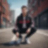 Black Adidas jacket with prominent red stripes showcased against a vibrant urban backdrop