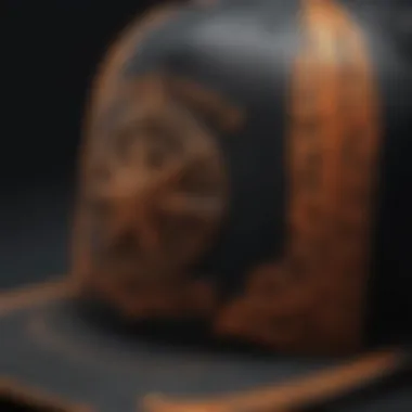 Close-up of the intricate design on a black and orange trucker hat