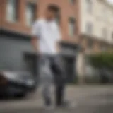 Stylish skateboarder wearing black and white tie dye sweatpants in an urban setting