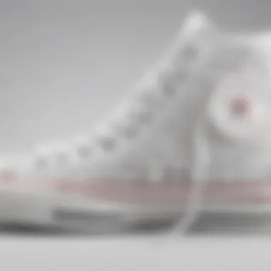 Close-up of Converse white high tops showcasing intricate design details