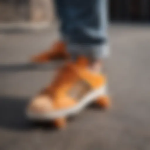 Close-up of orange Adidas Shell Toes on a skateboard