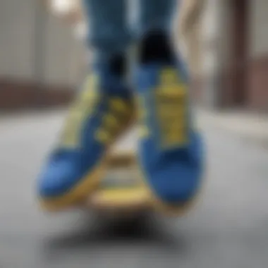 Close-up of blue and yellow Adidas shoes on a skateboard