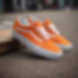 Vibrant orange and white Vans shoes on a skateboard