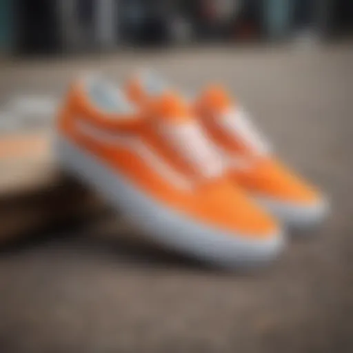 Vibrant orange and white Vans shoes on a skateboard