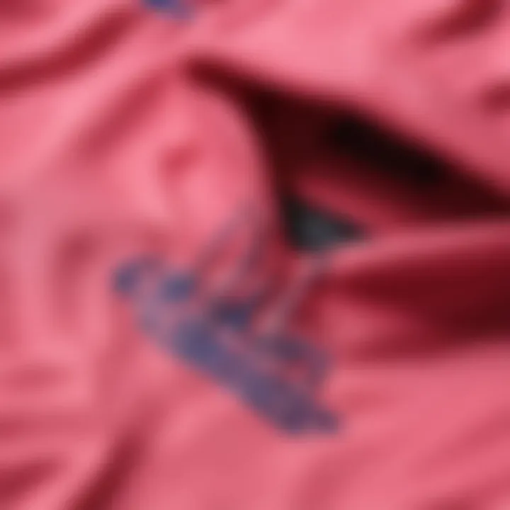 Close-up of the fabric texture and design of the neon pink Champion hoodie