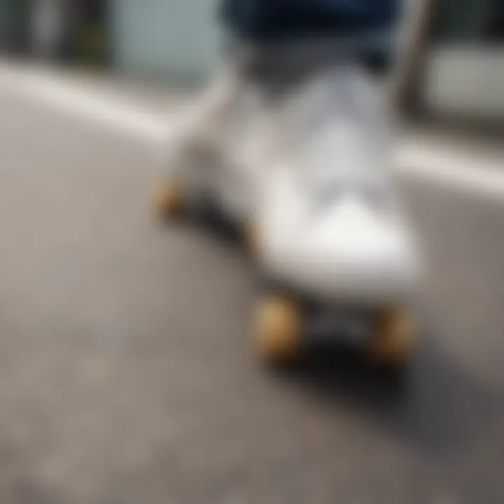 Close-up of white laced shoes on a skateboard deck