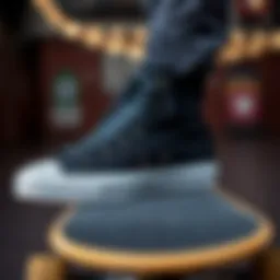 Close-up view of black Converse high tops on a skateboard