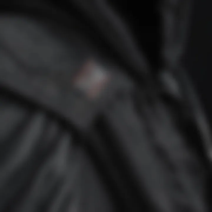 Close-up of the fabric details and stitching of a black hooded vest, emphasizing quality and design.