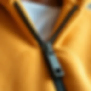 Close-up of a fleece hoodie zipper, highlighting quality craftsmanship and design details.